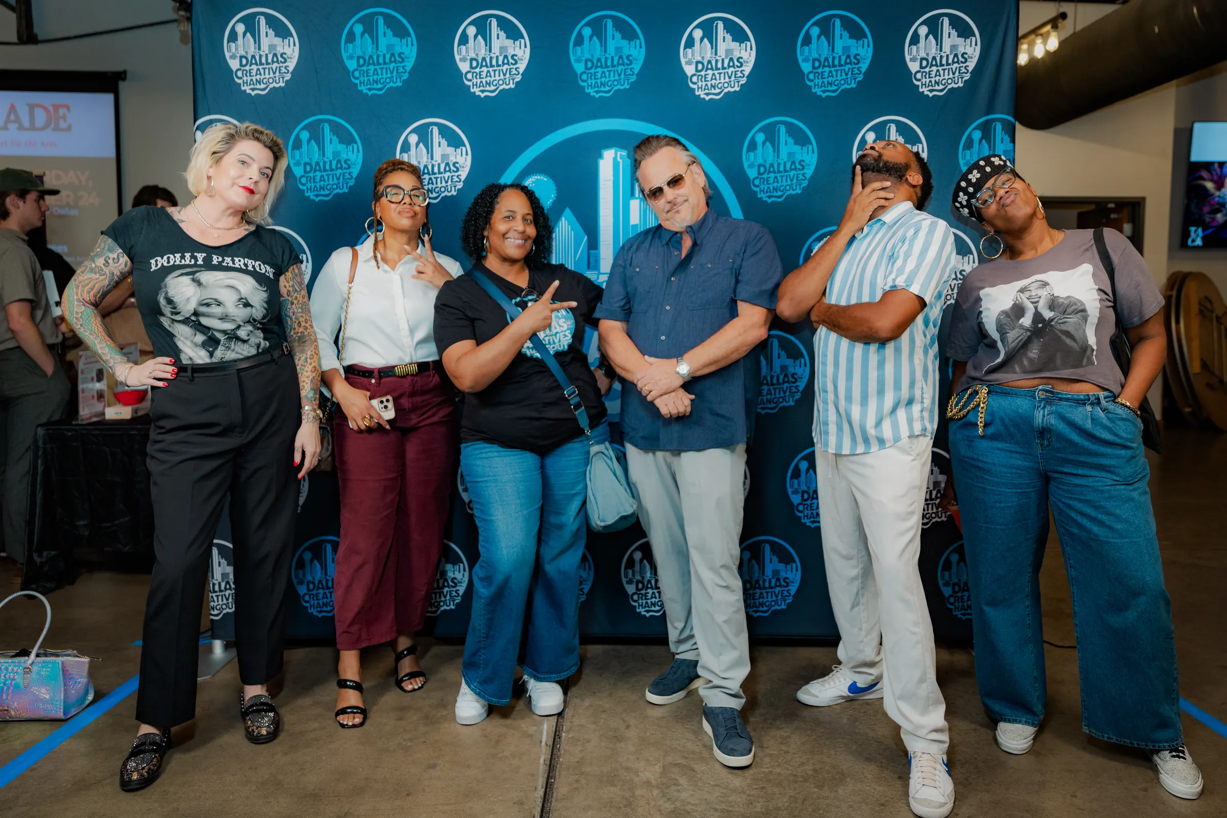 A group posing in front of the Hangout backdrop
