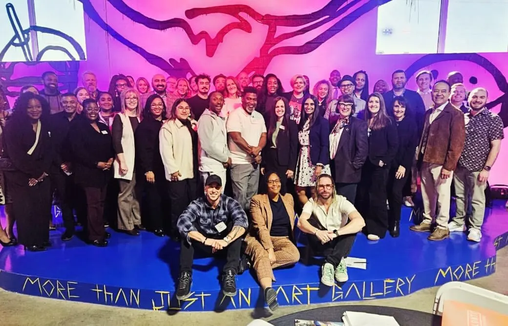 The Arts & Entertainment Sector Partnership group in front of a painted mural